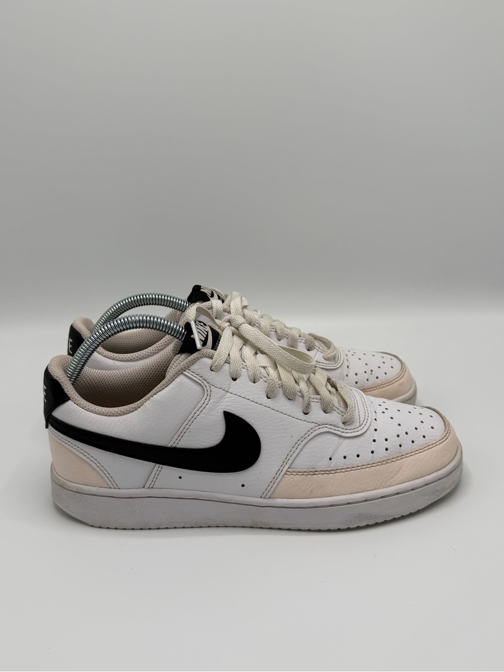 Nike Kids White Sneakers with Black Swoosh and Cream Accents